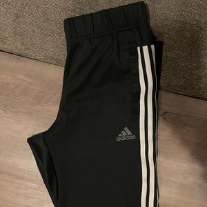 Black adidas joggers with zipper at ankle